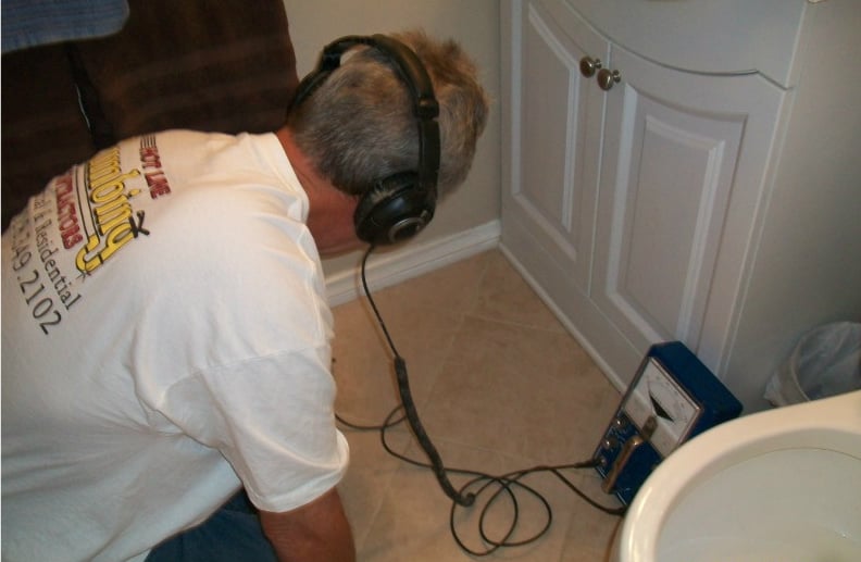 Hotline Plumbing technician performing leak detection